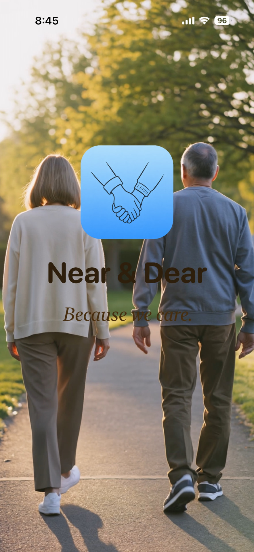 Near & Dear app splash screen showing an older couple walking together with the tagline Because we care.